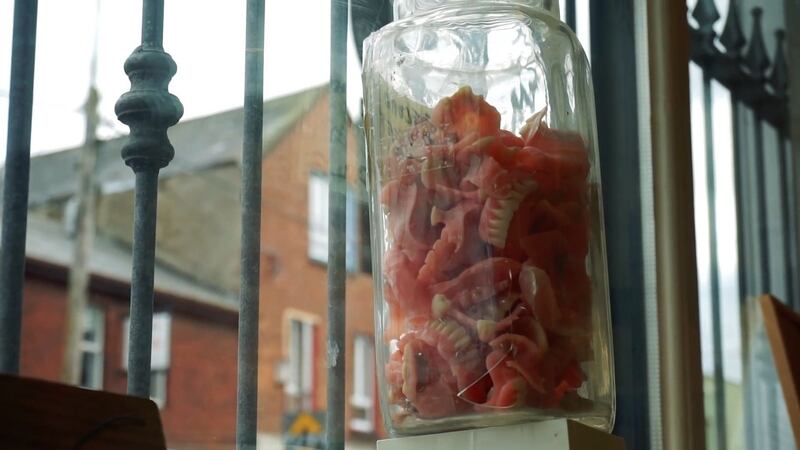 A jar of second-hand dentures in a window of Anthony O’Halloran’s house in  Limerick city
