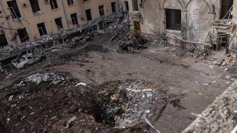 A crater yawns in the courtyard of the destroyed Kharkiv Regional State Administration building  in Kharkiv, Ukraine, after Russian shelling. Photograph: Chris McGrath/Getty