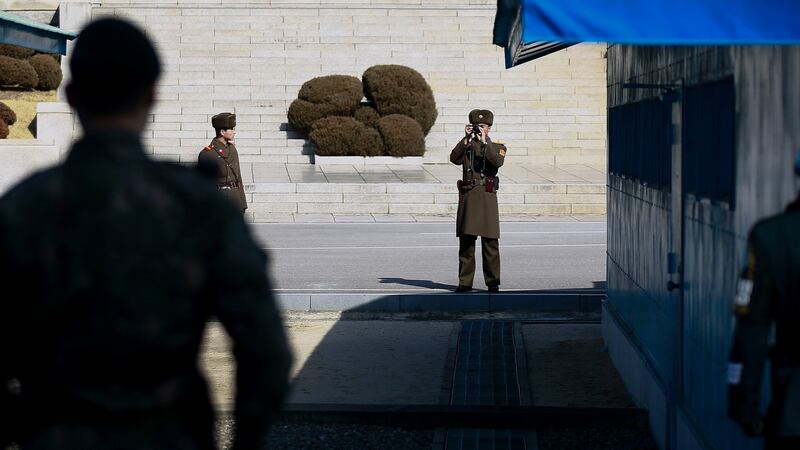 A North Korean soldier (C) takes pictures during the visit of Julie Bishop (not pictured), Australian Minister for Foreign Affairs,at the  (DMZ) in the border village of Panmunjom, South Korea in February. Photograph: Kim Hee-Chul/EPA
