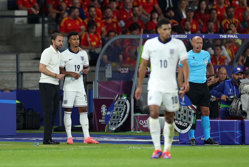 BERLIN, GERMANY - JULY 14: Gareth Southgate, Head Coach of England, speaks with Ollie Watkins of England as he prepares to come on as a substitute during the UEFA EURO 2024 final match between Spain and England at Olympiastadion on July 14, 2024 in Berlin, Germany. (Photo by Richard Pelham/Getty Images)