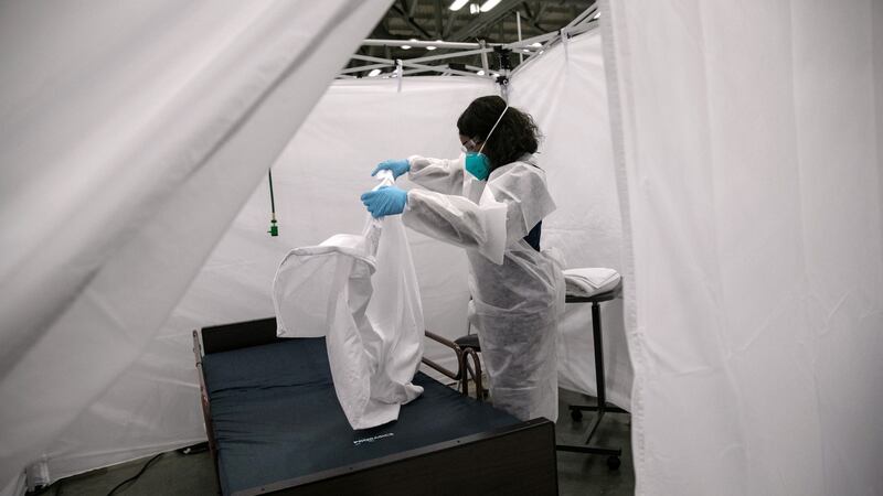 A nurse makes a bed in a Covid-19 isolation bay at the Austin Convention Center  in Austin, Texas. Photograph: John Moore/Getty