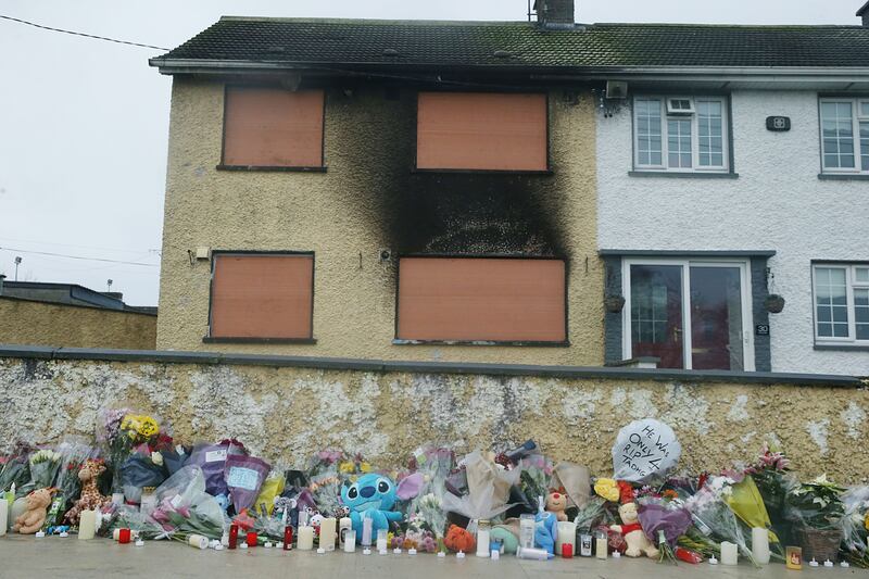 Floral tributes to Mary Holt and Tadgh Farrell last December outside the house in Castleview Park, Edenderry, Co Offaly. Photograph: Stephen Collins/Collins