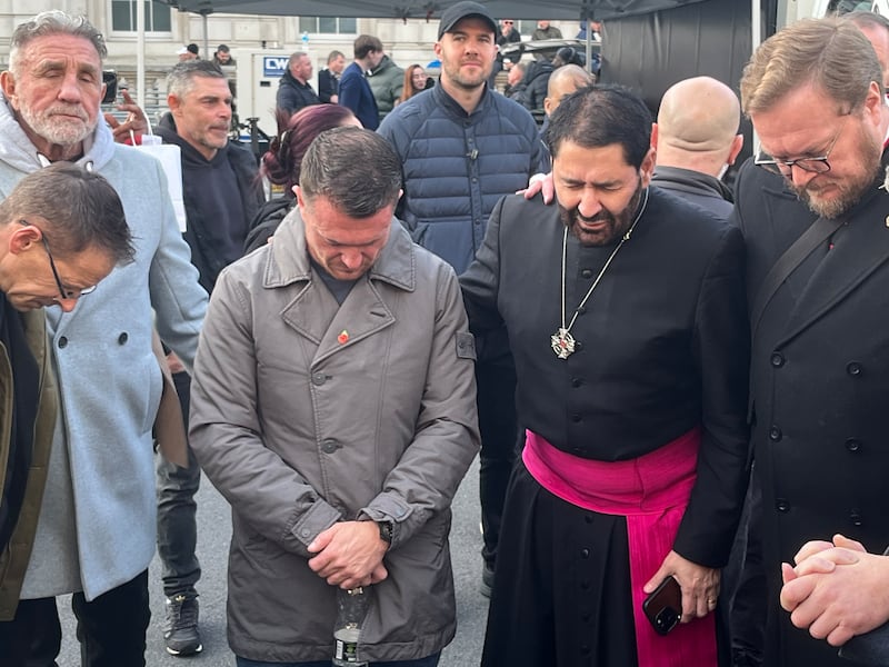 Robinson praying backstage with his associates before the event in Whitehall kicked off. Photograph: Mark Paul