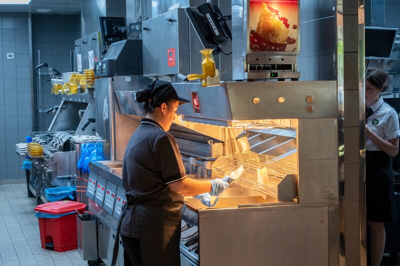 Kitchen staff work on orders. Photograph: Dmitry Serebryakov/AP