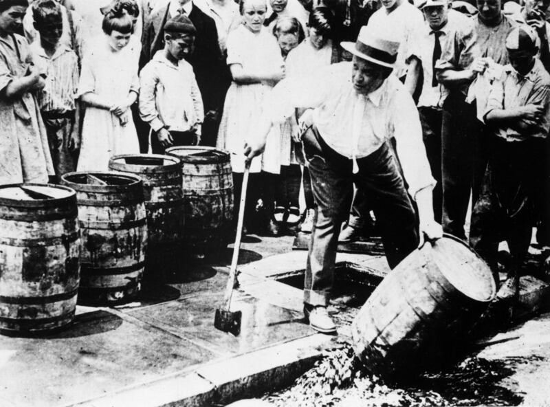 Circa 1920: A man destroying barrels of alcohol during prohibition in America. Phototgraph: Getty Images