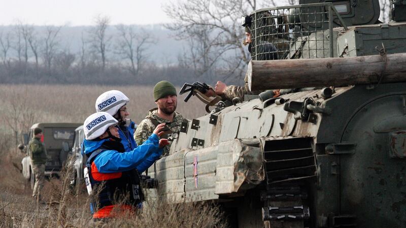OSCE observers check a Ukrainian serviceman’s weapons near Bohdanivka village, Ukraine, in October 2021. Photograph: Vadim Kot/EPA