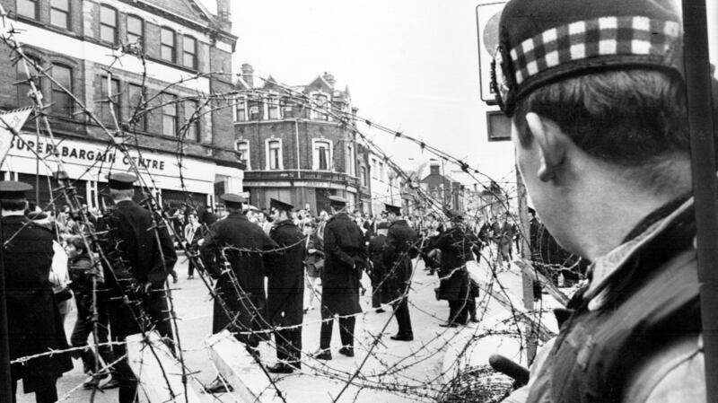 A Scottish soldier watches a loyalist parade in Belfast in 1970. Photograph:  AFP/Getty Images
