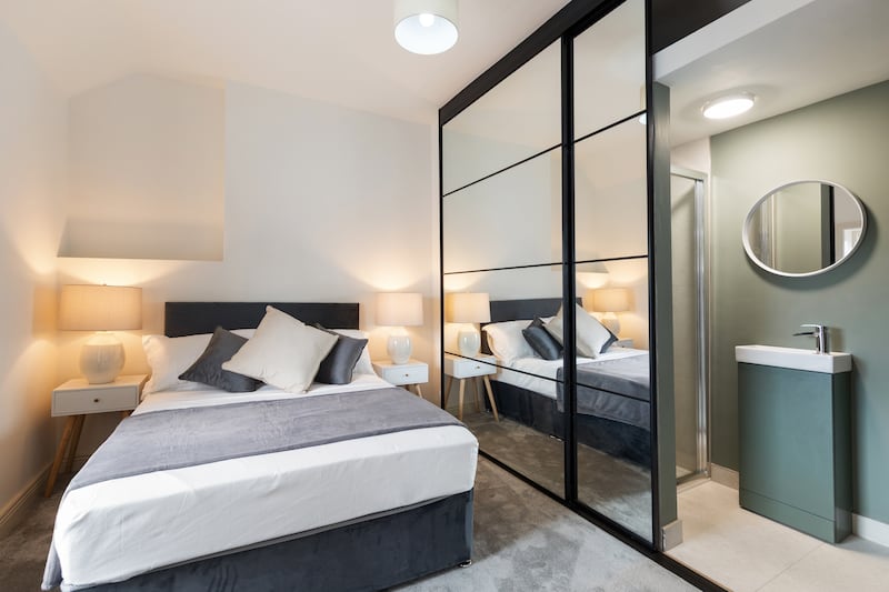 En suite in the principal bedroom is cleverly hidden behind sliding doors
