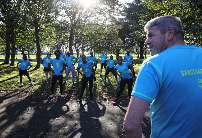 Graham Clifford, founder of Sanctuary Runners,  warms up runners in Fairview Park. Photograph: Alan Betson

