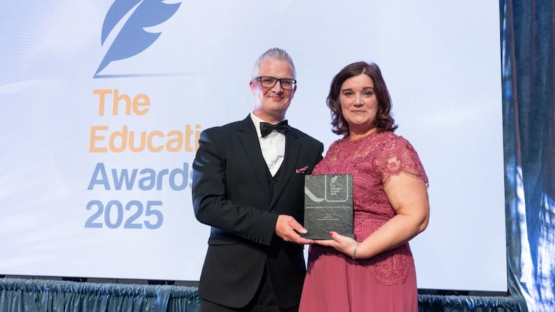 Tomas Finneran, awards judge, presents the best use of educational teachnology/ICT initiative to Mary Walsh O'Shea, WWETB