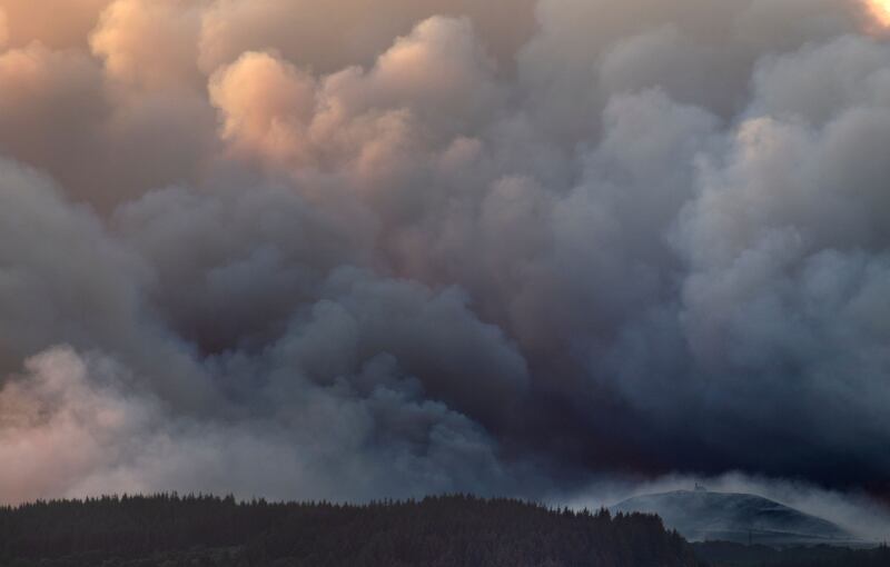 The Saint-Michel-de-Braspart chapel is seen amid the smoke from a wildfire in Braspart, western France on Monday night. Photograph: Fred Tanneau/Getty 