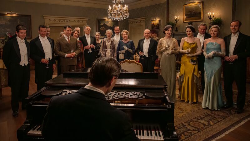 The cast of Downton Abbey gather in a grand drawing room. Photograph: Rory Mulvey/Focus Features