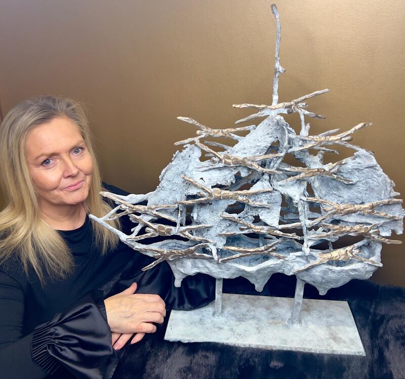 Jacqueline O'Donovan with the famine ship sculpture by John Behan