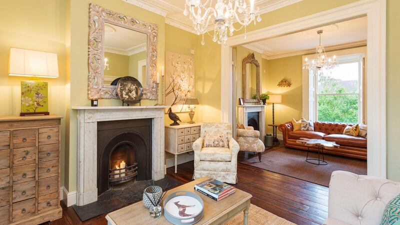 Interconnecting reception rooms, connected by double doors, showcase matching marble fireplaces.