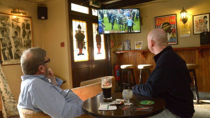 Chaplin’s bar  publican John Collins with punter Dan Gallagher: ‘A lot of my regulars, a good few that had medical issues, for example, still haven’t frequented the pub, and I can understand that,’ says Collins. Photograph: Denis Boyle