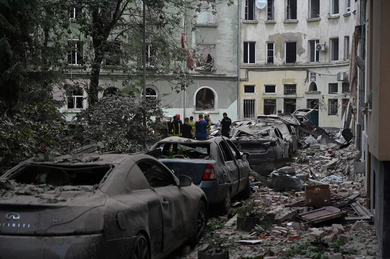 Rescuers stand in front of an apartment building that was partially destroyed by a Russian missile strike in the western Ukrainian city of Lviv on July 6th. Photograph: Yuriy Dyachyshyn/AFP via Getty