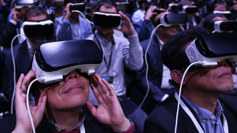Delegates use Gear VR (virtual reality) headsets, manufactured by Samsung, at the launch  ahead of the Mobile World Congress in Barcelona, Spain. Photograph: Chris Ratcliffe/Bloomberg