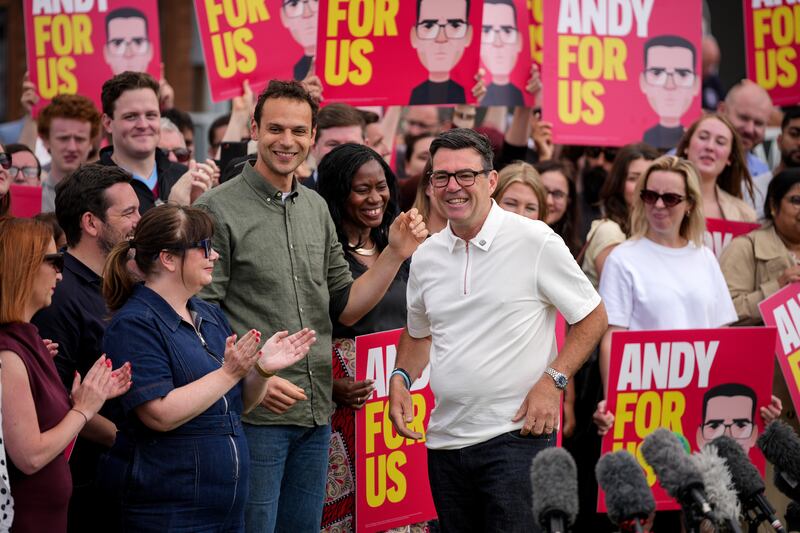 Andy Burnham celebrating his victory at Ashton Town Football Club in Makerfield, England. Photograph: Christopher Furlong/Getty Images)