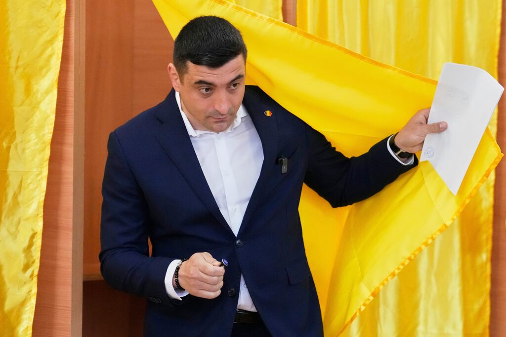 George Simion exits a voting booth before casting his vote. Photograph: Vadim Ghirda/AP