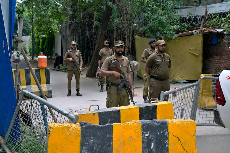 Police officers stand guard outside the residence of Pakistan’s former prime minister Imran Khan in Lahore on Saturday. Photograph: KM Chaudary/AP