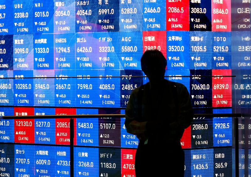 A man stands before a stock market indicator board in Tokyo on Thursday. Photograph: Franck Robichon/EPA