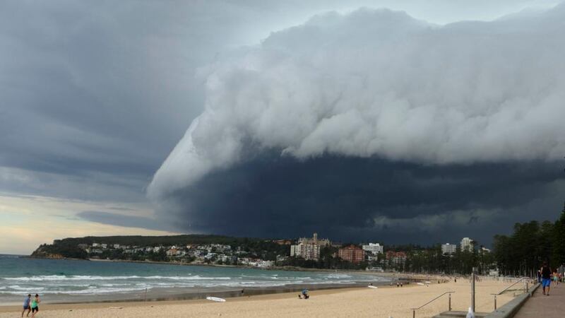 A wave-like cloud looms over Sydney’s Manly Beach during an afternoon storm front. Photograph: Will Burgess /Reuters