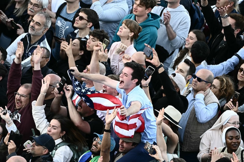 A man waves a US flag on St Peter's Square as the newly elected pope is announced. Photo: Getty Images