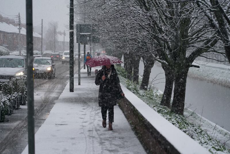 Snow falling in Dublin's Dolphin Barn on Friday morning. A yellow warning is in place for Dublin, Louth, Meath and Wicklow until 3am on Saturday. Photograph: Enda O'Dowd 