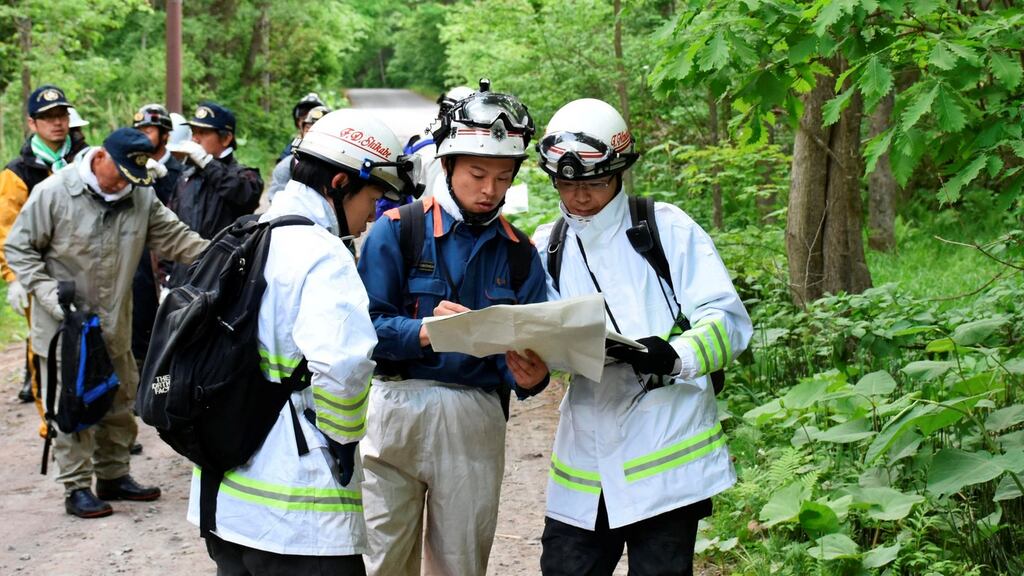 People search for a seven-year-old boy who went missing two days earlier, in Nanae town on the northernmost Japanese main island of Hokkaido, Japan on Monday. Photograph: Kyodo/Reuters