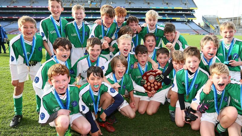 Photograph: Scoil Bhríde  captain Luke Mac Giolla Mhuire celebrates with his teammates after they beat Swords Educate Together NS in the Corn an Chéid final at Croke Park. Photograph: Frank McGrath