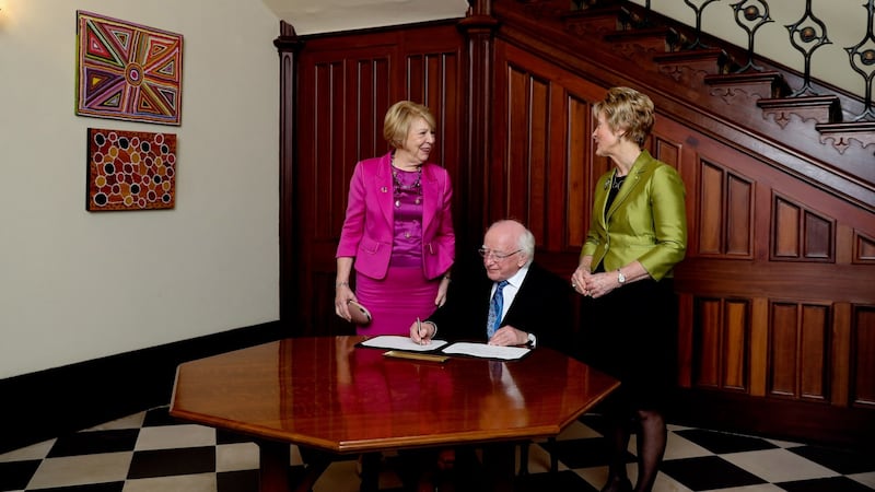 President Michael D Higgins signs a visitor book during a welcome ceremony with the  Governor of Western Australia Kerry Sanderson. Photograph: Maxwells