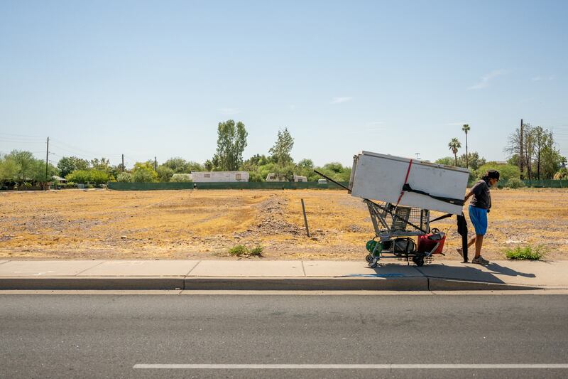 A person hauls a refrigerator down a path on Thursday in Phoenix. Photograph: Brandon Bell/Getty Images