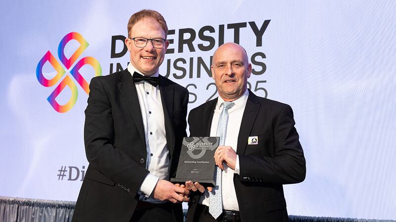 Barry Walsh, awards judge, presents the outstanding contribution award to Billy Hann, Dublin Bus