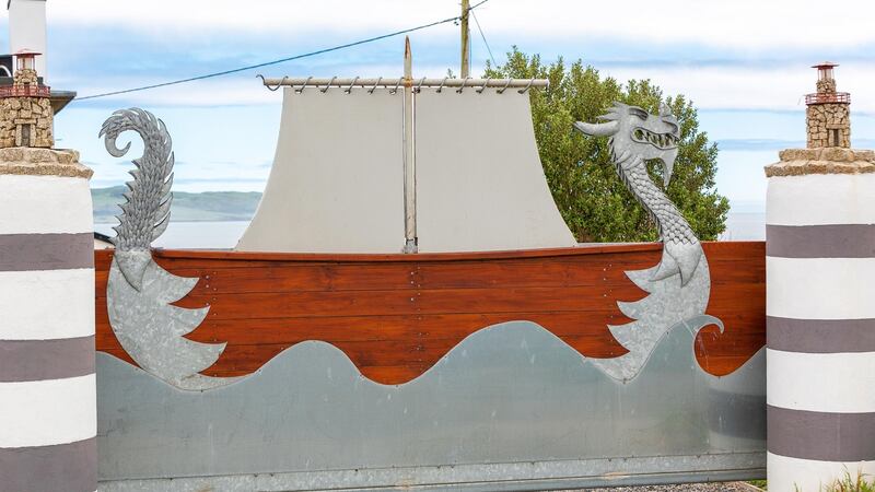 The  Viking-themed electric gates at the entrance to the house.