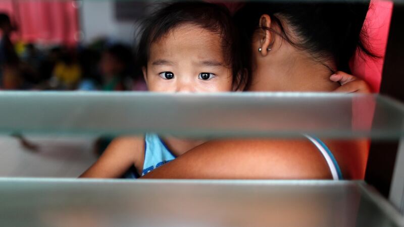 Filipino villagers rest inside a school turned into a temporary shelter ahead of Typhoon Mangkhut landfall in the region. Photograph: Francis R. Malasig/EPA