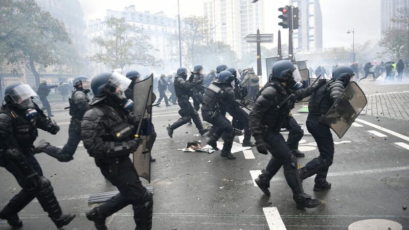 Riot mobile gendarmes run on place d’Italie in Paris on Saturday. Photograph: martin Bureau/AFP/Getty Images