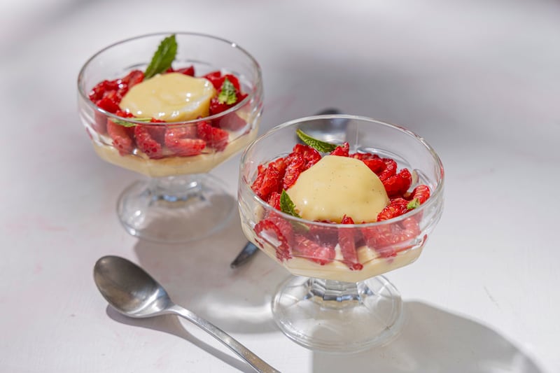 Poached meringues with raspberries and custard. Photograph: Harry Weir