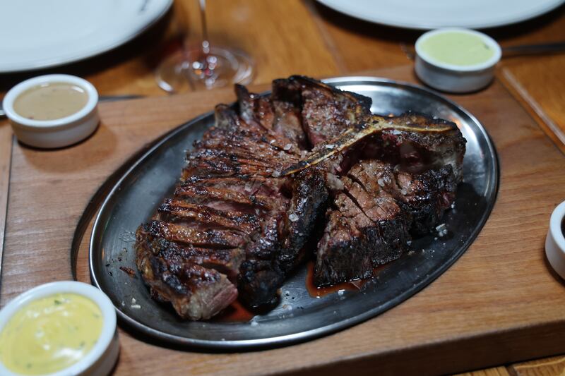 32oz Porterhouse sharing steak with chips, onion rings, mashed potato, creamed spinach, broccoli, caramelised onions and mushrooms. Photograph: Bryan O’Brien