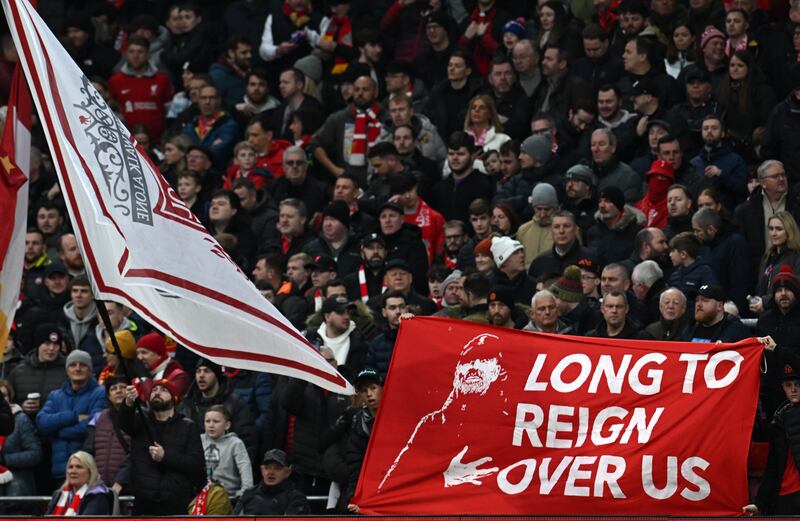 A fan holds a tribute to Liverpool's German manager Jurgen Klopp. Photograph: Paul Ellis/AFP via Getty Images  