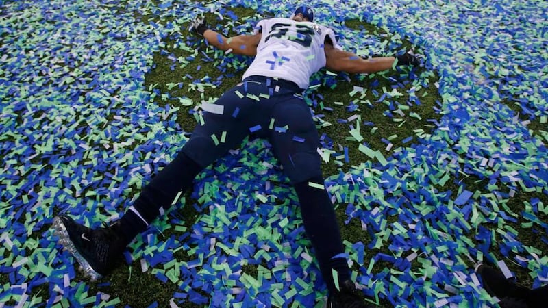 Seattle Seahawks’ Malcom Smith makes an angel in the confetti after his team defeated the Denver Broncos in the NFL Super Bowl XLVIII football game in East Rutherford, New Jersey. Photograph: Shannon Stapleton/Reuters