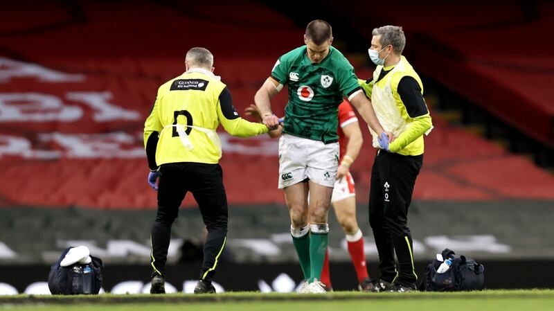 Johnny Sexton gets treatment from Dr. Ciaran Cosgrave and physio Keith Fox having suffered a head injury in the game against Wales at the Principality Stadium. Photograph: Laszlo Geczo/Inpho