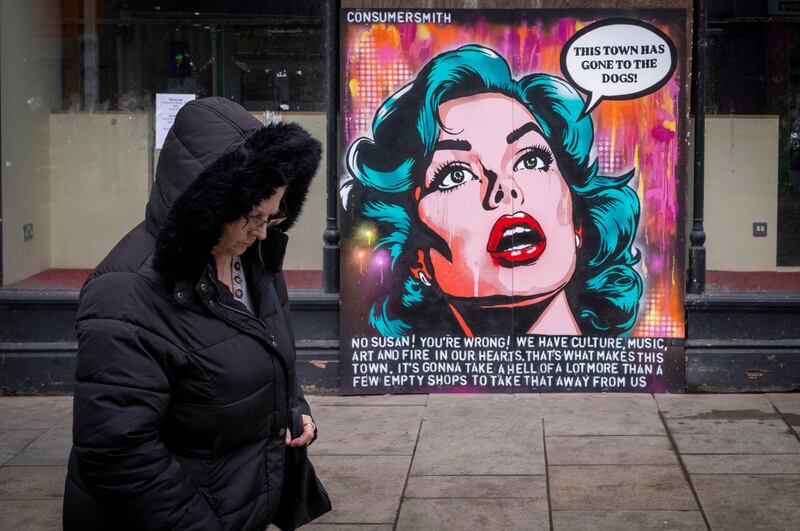 A woman walks past a closed down shop in Newport, Wales. Photograph: Matthew Horwood/Getty Images