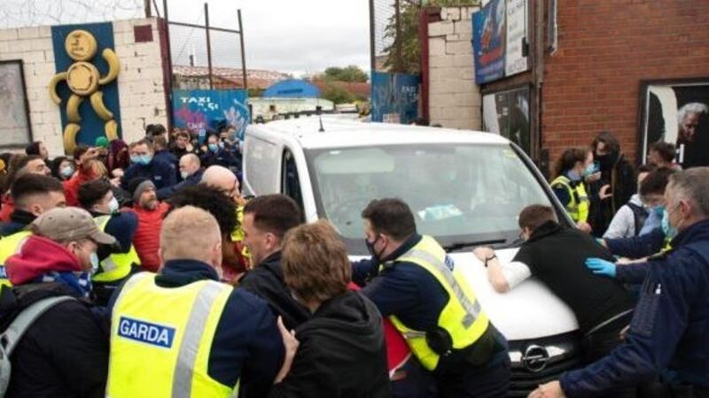 Gardaí attempt to hold back protestors while a work van sought to leave a site on Prussia Street in Dublin city centre where people were evicted. Photograph: Damien Eagers