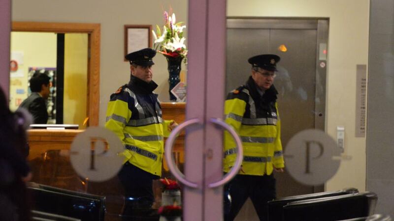 Gardai are seen at  the Plaza Hotel in Tallaght yesterday  where the body of a woman was  found in a room at the hotelPhotograph: Alan Betson/The Irish Times