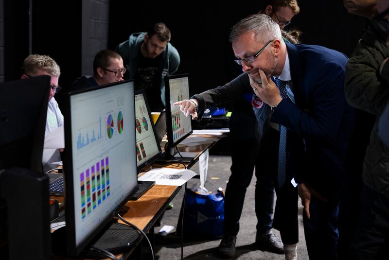 The Minister for Children Roderic O'Gorman  decodes the data  at the count centre in the RDS . Photograph:  Sam Boal/Collins Photos. 





