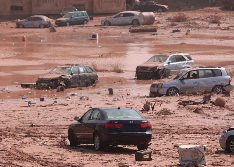 Wrecked cars sit in the receding waters and mud following the flooding in Derna. Photograph: Handout/Anadolu Agency via Getty