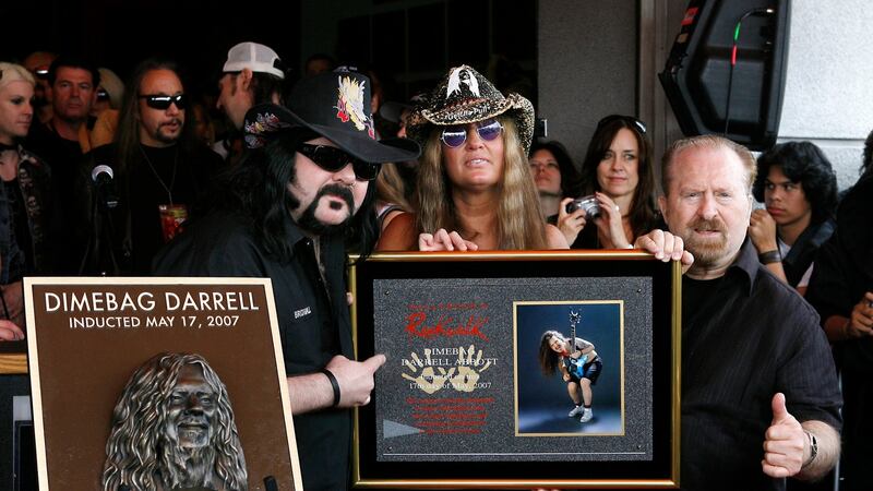Pantera founder and drummer Vinnie Paul with Rita Hane and Jerry Abbott unveil a plaque in honour of former Pantera guitarist, the late Darrell ‘Dimebag’ Abbott during the induction to the Hollywood Rock Walk at Guitar Center, Hollywood, California, in 2007. File photograph:  Vince Bucci/Getty Images for VH1