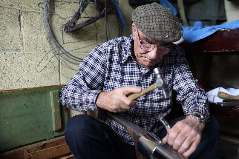 Collins' tinsmithing craft requires little soldering, and is carried out mostly with the use of small anvils and hammers and rivets. The metal is bent and tapped, hammered, rolled and riveted into shape. Photo: Bryan O'Brien/The Irish Times