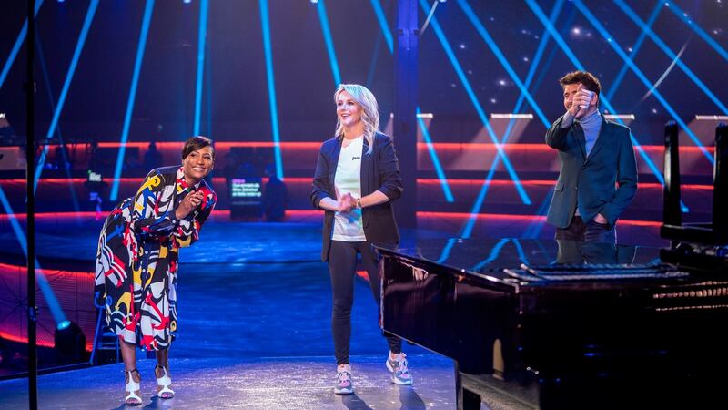 Hosts (from left) Edsilia Rombley, Chantal Janzen, and Jan Smit, joke during rehearsal for the Eurovision’s Europe Shine A Light remote television show. Photograph: AP