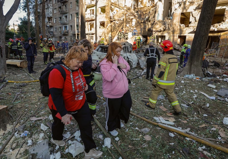 Residents at the site of a rocket strike on a five-storey residential building in Kyiv. Photograph: Sergey Dolzhenko/ EPA